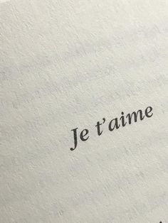 the word je t'aime written in black ink on an old typewriter