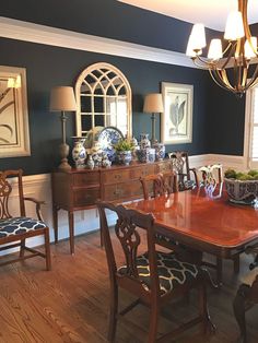 a dinning room table and chairs with blue walls