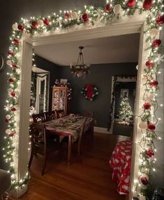 a dining room decorated for christmas with lights