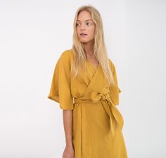 "MARY is a short sleeve robe style linen wrap dress with a self tie belt. DETAILS - Self tie belt with no closure or belt loops - Dolman style sleeves - Knee length - 100% lightweight European linen fabric - Cut and sewn to order just for you in our studio SIZING & FIT - Relaxed fit - True to size - Model is 5'8\" / 173cm and wearing a size M CARE FOR LINEN - Machine wash up to 30ºC/86ºF gentle cycle - Lay flat to dry or tumble dry low - Warm iron if needed - Do not bleach SIZE GUIDE Size conversion guide Size XS (US 0-2, IT 36-38, UK 4-6, Japan 3-5, France 32-34) Size S (US 4-6, IT 40-42, UK 8-10, Japan 7-9, France 36-38) Size M (US 8-10, IT 44-46, UK 12-14, Japan 11-13, France 40-42) Size L (US 12-14, IT 48-50, UK 16-18, Japan 15-17, France 44-46) Size XL (US 16-18, IT 52, UK 20-22, Japa Linen Wrap Dress, Kimono Wrap Dress, Linen Kimono, Linen Tunic Tops, Black Linen Dress, Kimono Wrap, Summer Linen Dresses, Dress For Summer, Dress Linen