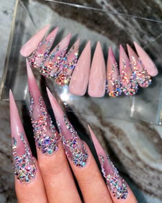 Four fingers with long, pointed, pink nails, and flames made of crystal on top.  A full set of nails with the same design are displayed in the background Flame Nails Short, Alcohol Cleanse, Flame Nails, Cleansing Pads, Pink Swarovski, Bling Acrylic Nails, Nail Length, Crystal Nails, Crystal Ab