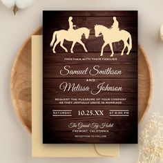 a wedding card with the silhouette of two people riding horses on top of a wooden background