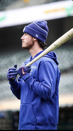 a man holding a baseball bat on top of a field