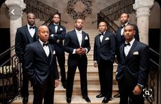 a group of men in tuxedos standing on stairs