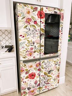 a floral painted refrigerator freezer in a kitchen