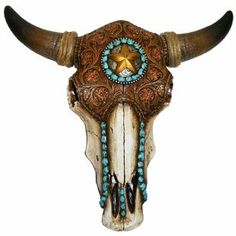 a cow skull with turquoise beads and a star on it's head is shown