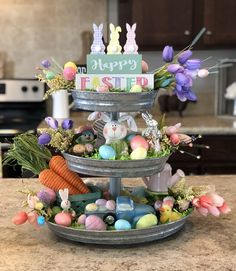 three tiered tray with easter decorations on it