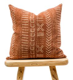 a brown pillow sitting on top of a wooden stool