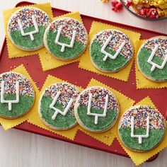 decorated cookies with numbers and sprinkles on a tray