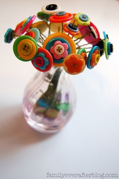 a vase filled with lots of colorful buttons