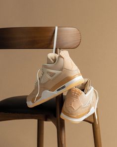 a pair of shoes hanging from a wooden chair