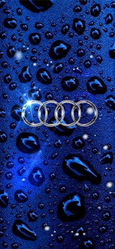 the front end of an audi car with water droplets on it