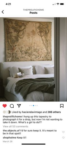 an instagramted photo of a bed with a tapestry hanging above it