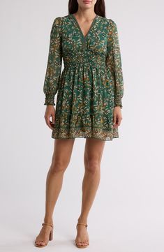 A smocked waist shapes the silhouette of this floral-patterned dress framed by long sleeves. 35 1/2" length V-neck Long sleeves with smocked cuffs Slips on over head Lined 100% polyester Machine wash, line dry Imported Model stats: 5'10" height, 32" bust, 25" waist, 36" hip. Model is wearing size Small. Green Long Sleeve Dress With Smocked Cuffs, Green Smocked Long Sleeve Dress For Fall, Green Long Sleeve Smocked Dress For Fall, Green Smocked Dress With Long Sleeves, Summer Smocked Long Sleeve Dress With Elastic Waistband, Summer Long Sleeve Smocked Dress With Elastic Waistband, Fitted Long Sleeve Smocked Dress With Floral Print, Long Sleeve Smocked Dress With Elastic Waistband For Spring, Long Sleeve Smocked Dress With Elastic Waistband For Summer