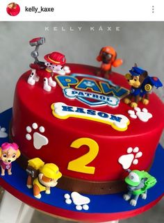 a red cake with paw patrol characters on it