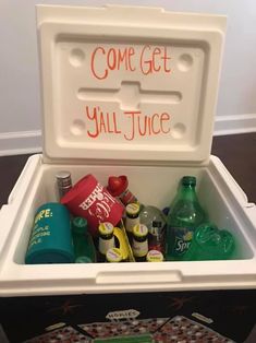 a cooler filled with lots of drinks and condiments on top of a table