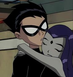 an animated image of a man hugging a woman with her eyes closed and catwoman on the forehead