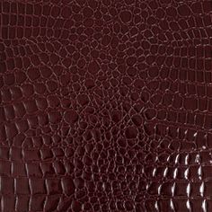 an alligator skin pattern in red and dark brown colors, with the crocodile print on it