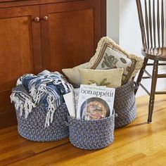 a chair and some baskets on the floor in front of a counter with books, magazines and other items