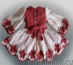 a red and white knitted dress with flowers on the front, made to look like a doll