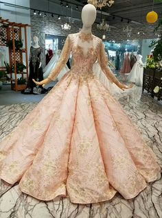 This specially embellished wedding dress from kemedress, is a good buy for brides. After years of producing beautiful dresses for brides with excellent quality, this pink colored ball gown dress is another high-quality dress from us. This gown is made from sequins fabric that is wrinkle-free, its maintenance is minimal. The neckline is a high neck, it has a long sleeve that is made from sequins fabric. This luxury wedding dress has a floor-length hemline, which makes it regal and elegant. Silhou Batmitzvah Dress, Princess Attire, Feminine Inspiration, Arm Exercise, Pretty Products, Wedding Dress With Train, Baju Kahwin, Poofy Dress, Embellished Wedding Dress