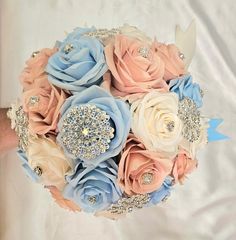 a bridal bouquet with blue and peach flowers