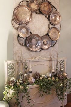 a living room with a fire place and plates on the mantle in front of it