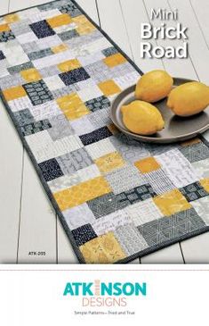 a table runner with three lemons on it and the words, mini brick road