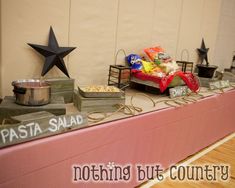 a table topped with lots of food next to a wall