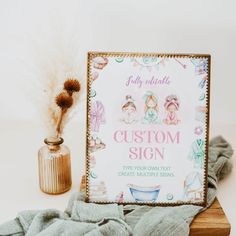 a wooden sign sitting on top of a table next to a vase