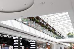 the inside of a shopping mall with people walking around