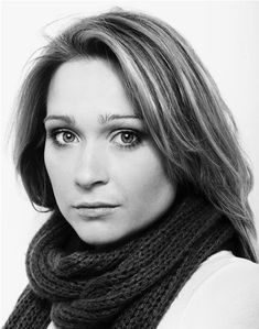 a black and white photo of a woman wearing a scarf