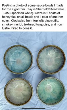 four blue and white bowls sitting next to each other on top of a tablecloth