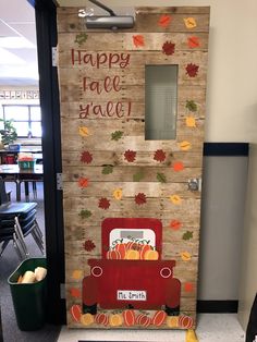 a door decorated with fall leaves and a red truck that says happy fall y'all