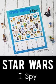 the star wars i spy game is shown on a white wooden table with toys and stickers