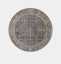 a round rug with an intricate design in blue and beige colors on a white background