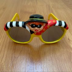 Nwt Vintage Mcdonald’s Hamburglar Kids Sunglasses. Yellow Sunglasses. Hamburglar Character At Top Of Glasses And Spell Out On Right Arm Temple. Glasses Have Been Removed From Original Bag. One Size Fits Most. Novelty Sunglasses For Summer, Yellow Mirrored Sunglasses For Beach, Retro Plastic Sunglasses, Retro Yellow Sunglasses With Mirrored Lenses, Yellow Retro Plastic Sunglasses, Yellow Sunglasses, Party Sunglasses, Original Bags, Kids Sunglasses