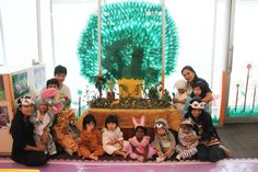 a group of children dressed up in animal costumes posing for a photo with their parents