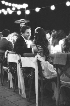 black and white photograph of a bride and groom hugging each other at their wedding reception