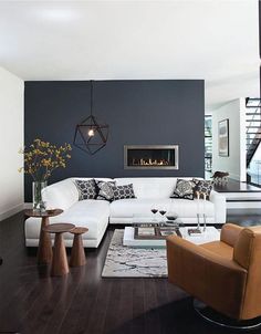 a living room filled with furniture and a painting hanging on the wall over a fire place