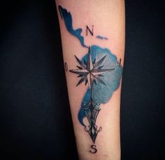 a compass tattoo on the arm