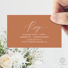 a person holding up a business card with flowers in front of it and the words rsp on it