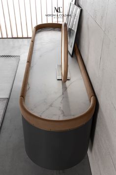 a table with a magazine rack on top of it in front of a wall and floor