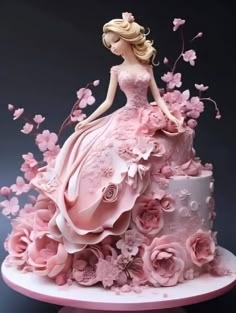 a cake decorated with pink flowers and a woman in a dress sitting on top of it