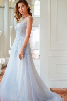 a woman in a blue dress posing for the camera