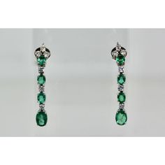 This is part of Chairish’s Fine Jewelry assortment.  Emerald Drop Dangle Earrings 18K  These lovely Emerald Drop Earrings are done in 18K White Gold and is set with 4 Emeralds each, 6 Diamonds of 0.15 points each, 3 Emeralds of approximately 1/2 Carat each and the bottom Emerald 1 carat each. TCW is 5 carats. The length of these earrings are 4 cm and it weighs 7.9 grams. This earrings are a nice addition to your Emerald wardrobe as they are simple drop Earrings and the Emeralds are of nice color Elegant Oval Diamond Earrings With 17 Jewels, Elegant Oval Hallmarked Earrings, Classic Hand Set Yellow Gold Earrings, Elegant Hallmarked Diamond Dangle Earrings, Elegant Dangle Diamond Earrings Hallmarked, Green Diamond Earrings For Formal Occasions, Fine Jewelry Long Drop Earrings For Formal Events, Green Linear Drop Earrings For Formal Occasions, Classic Green Diamond Drop Earrings