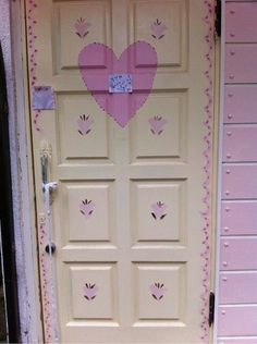 a pink door with a heart painted on it