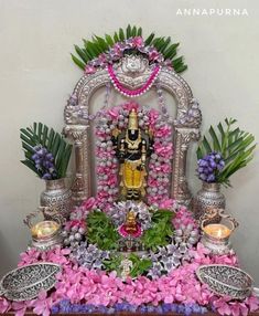 the statue is surrounded by flowers and candles