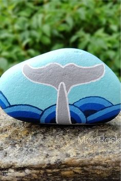 a rock with a whale tail painted on it