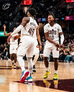 two basketball players are walking on the court